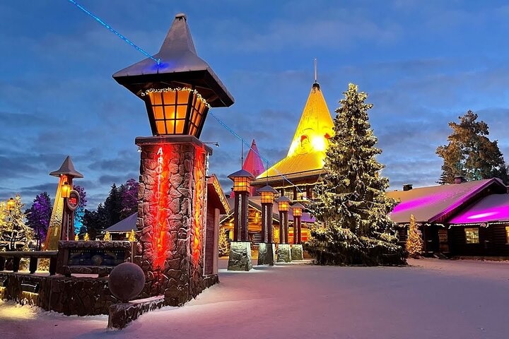 Interior of the Arctic Snow Hotel showing an ice-carved corridor with soft blue lighting